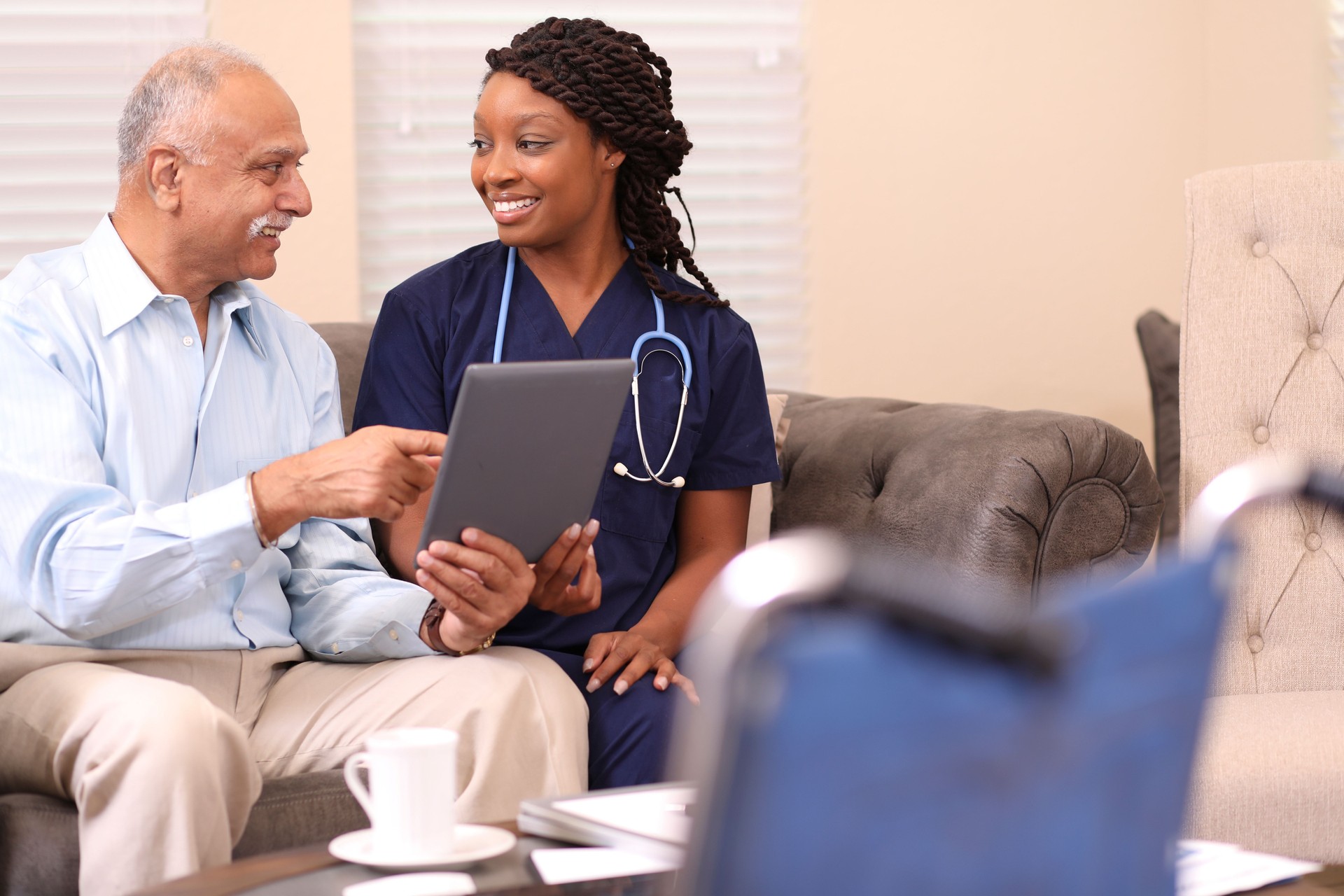 Senior adult man and home healthcare nurse.